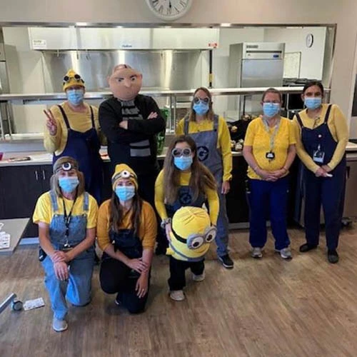 Staff dressed as minions and Gru from the movie Despicable Me.
