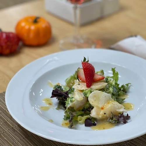 Thanksgiving salad with strawberries garnished on top.