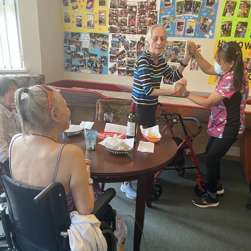 A old lady dancing with a young lady