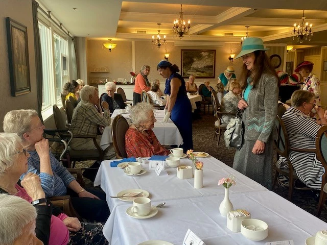 Seniors showing their vintage clothing to other seniors