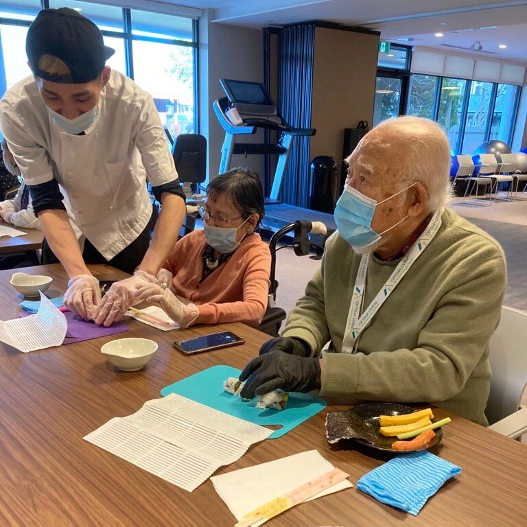 Residents enjoying making different types of sushi