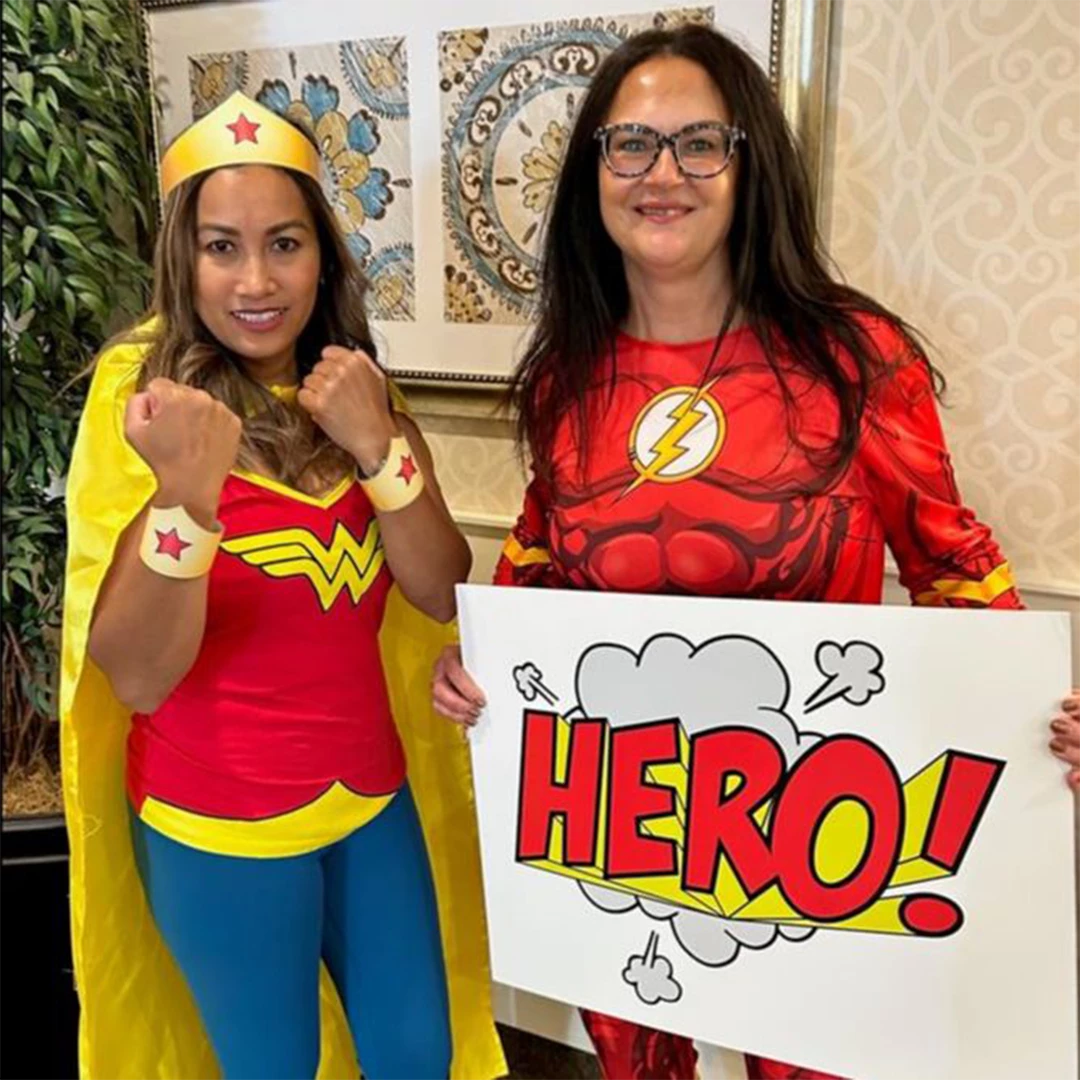 Staff in super hero costumes